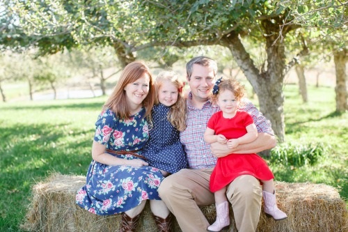 Happy family portrait in orchard.