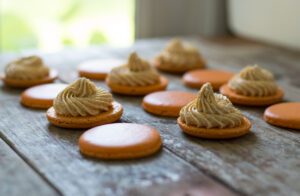 A wooden table topped with cookies covered in frosting.