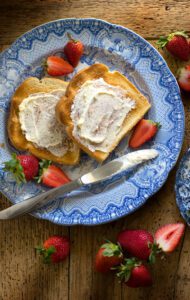 A plate with some bread and strawberries on it